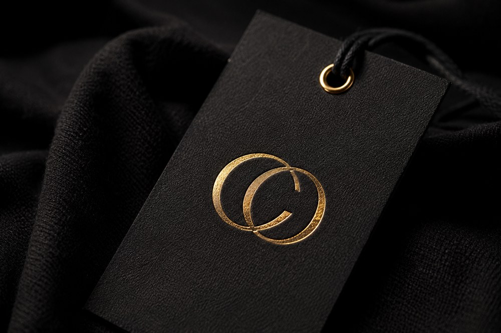 Fashion brand mark on a black garment tag